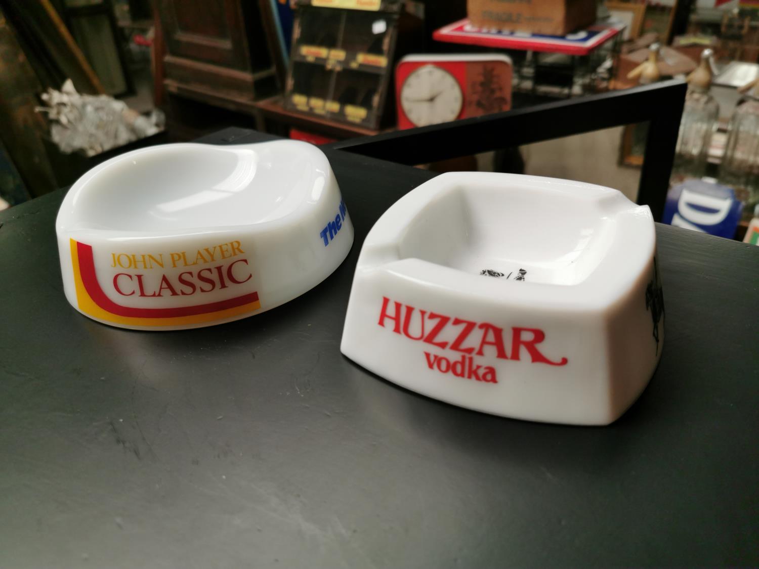 Two advertising ashtrays.