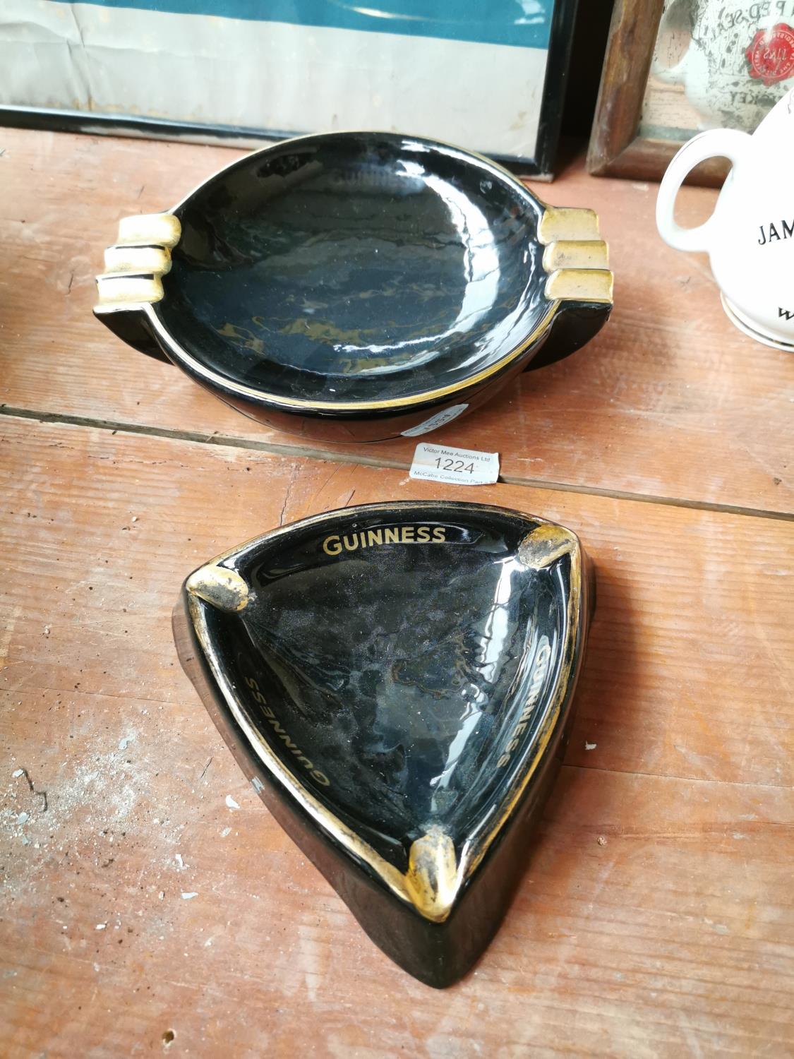 Two Guinness advertising ashtrays.