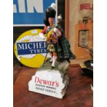 Dewar's Scotch Whiskey advertising figure.