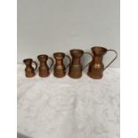 Graduated set of five copper jugs