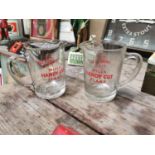 Two Wills cigarettes glass advertising jugs.