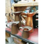 Set of four copper water jugs.