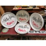 Four Carlsberg tin advertising drinks trays.