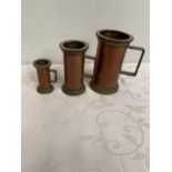 Graduated set of three copper and brass tankards