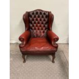 Leather ox-blood Chesterfield wing backed armchair.