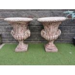 Pair of moulded stone Urns.