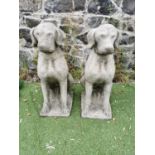 Pair of moulded stone seated Dogs.