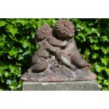 Sandstone sculpture of kissing cherubs