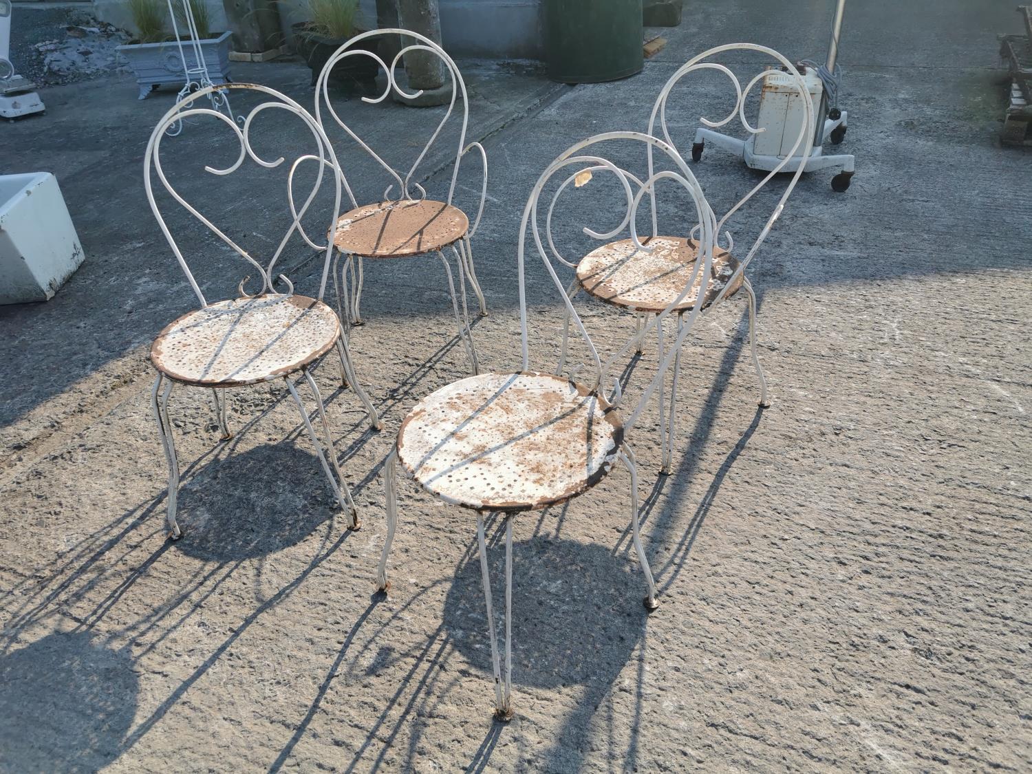 Set of four wrought iron garden chairs