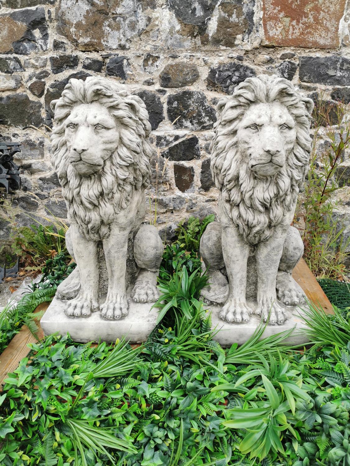 Pair of moulded stone seated Lions.