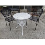 Cast iron garden table and two chairs.