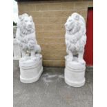 Pair of moulded stone seated Lions on pedestals.