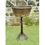 Cast iron planter on circular column base.