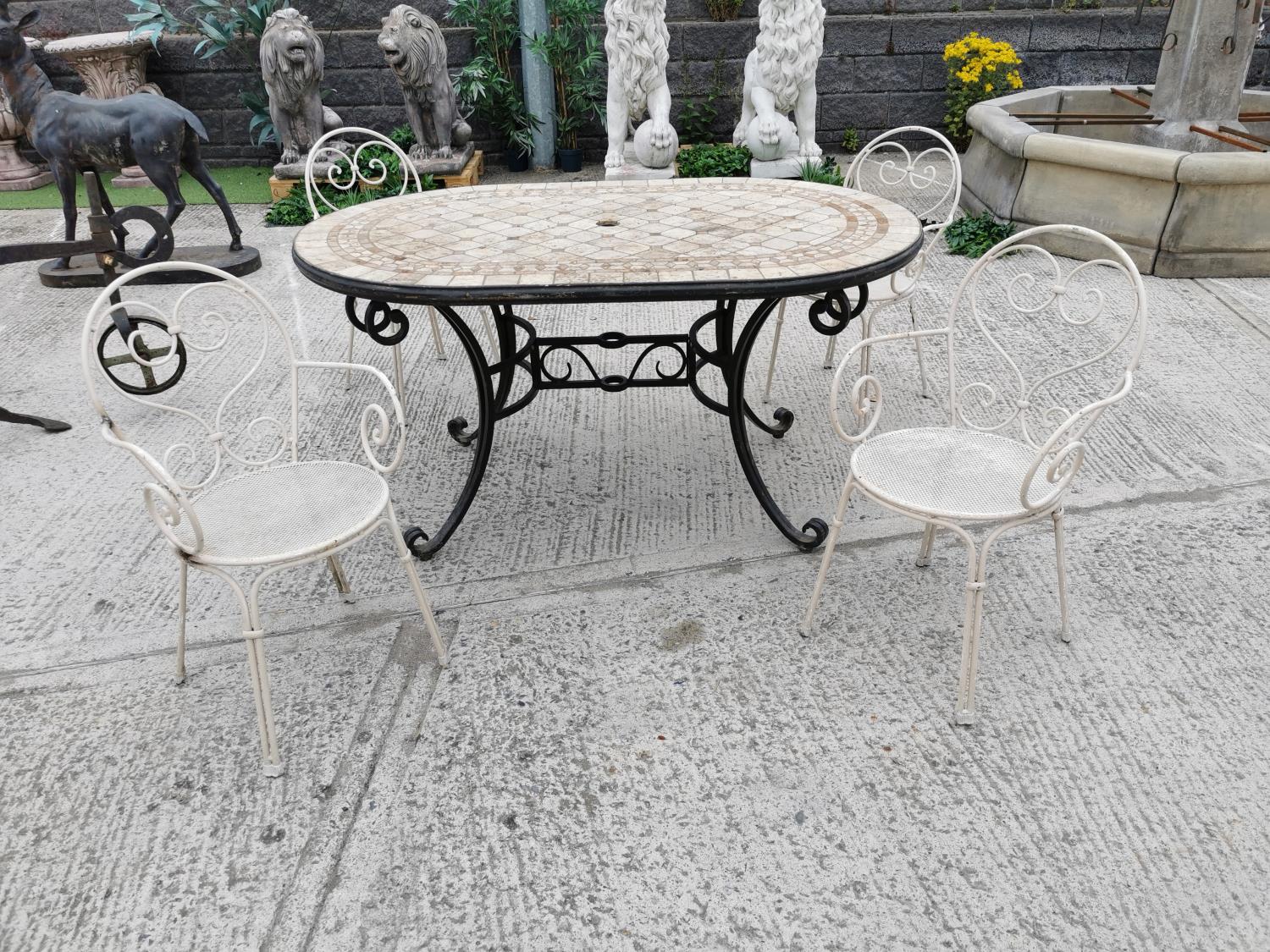 Wrought iron garden table and four chairs.