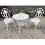 Decorative cast alloy garden table and two chairs.