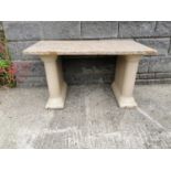 Garden table with stoneware pedestals and marble top.