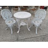 Cast iron garden table and two chairs.