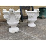 Pair of moulded stone urns.