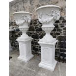 Pair of exceptional quality moulded stone urns.