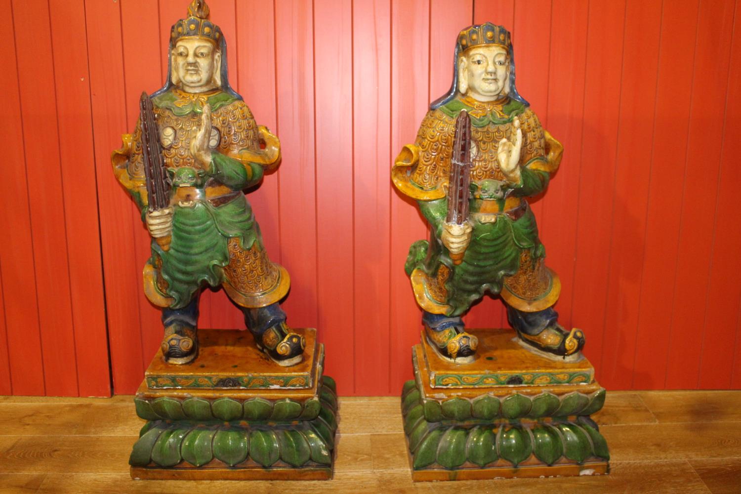 Pair of composition glazed models of Oriental warriors.