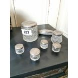 Collection of six cut glass dressing table jars