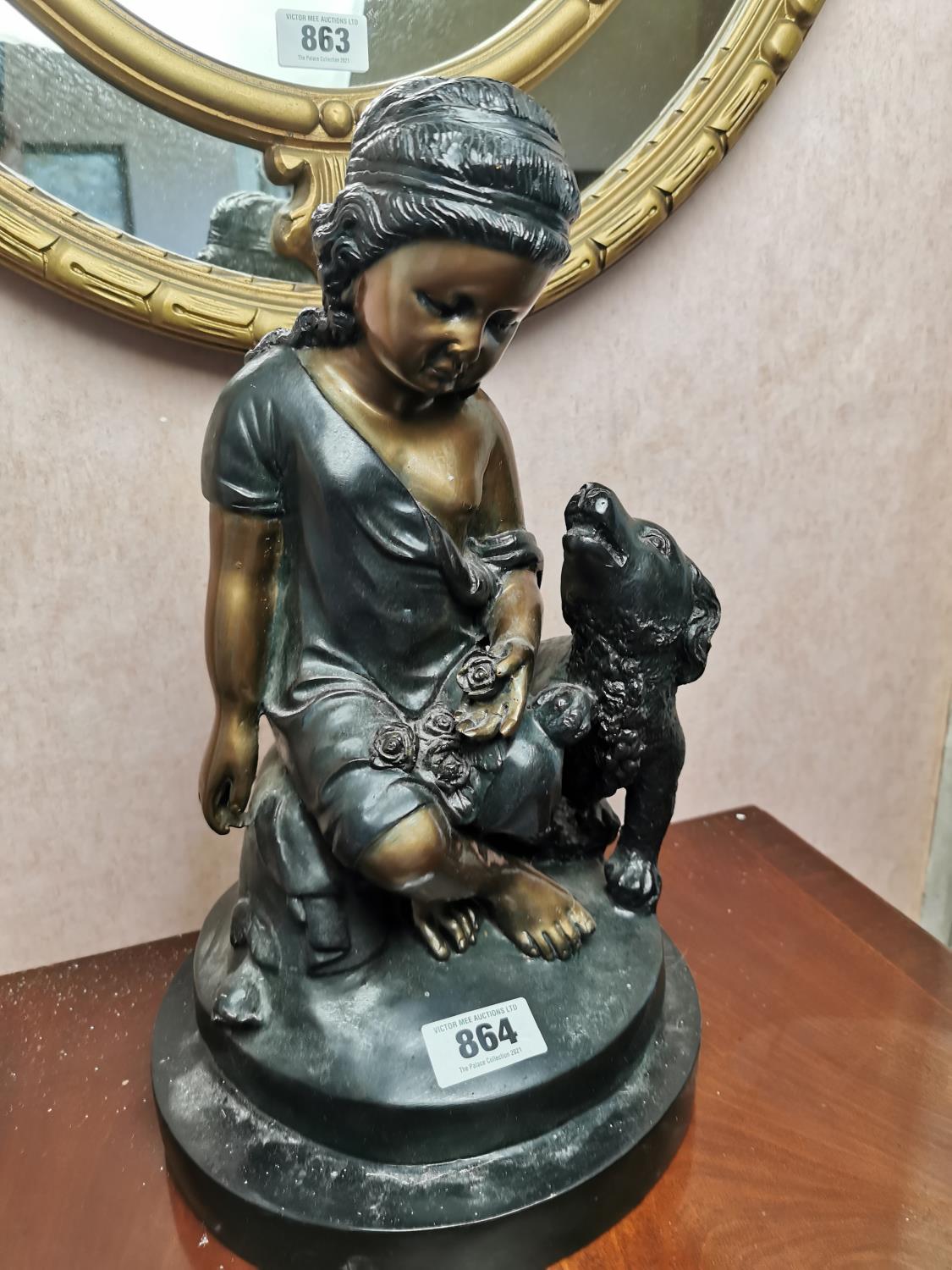 Resin model of a girl and her dog.