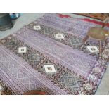 Decorative hand knotted carpet square.