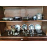 Two shelves of miscellaneous silver plate.