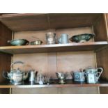 Two shelves of miscellaneous silver plate.