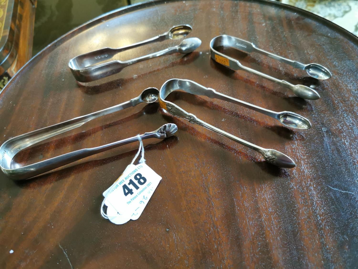 Four English silver sugar tongs