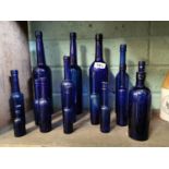 Fifteen 19th. C. Bristol blue glass Caster Oil bottles