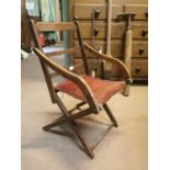 Early 20th. C. oak upholstered folding open armchair.