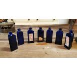 Seven Bristol blue glass poison bottles