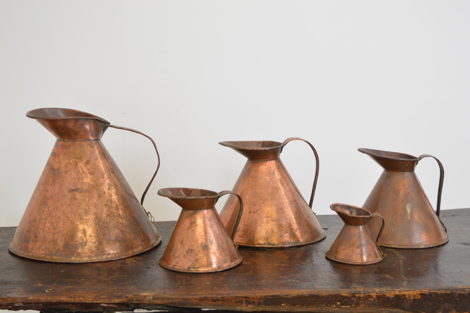 Set of six copper haystack measures.