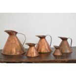 Set of six copper haystack measures.