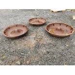 Three cast iron pig feeders