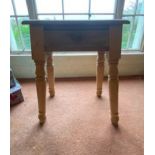 Pine coffee table raised on turned legs