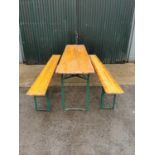 Metal and pine folding table and matching benches.