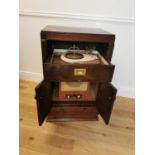 Art Deco record player in walnut cabinet.