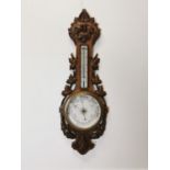 Edwardian carved oak barometer.