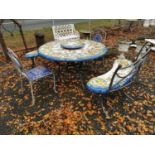 Wrought iron garden table, two benches and two chairs.