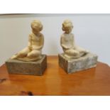 Pair of resin bookends on marble bases.