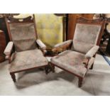 Pair of Edwardian carved oak and upholstered arm chairs.