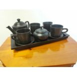 Oriental style ebony tea service on tray.
