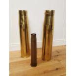 Three WWI brass gun shells.