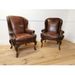 Pair of good quality leather upholstered wing backed armchairs