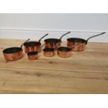Set of seven copper saucepans.