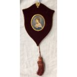 20TH CENTURY PORTRAIT MINIATURE IN A SHIELD SHAPED TASSEL FRAME