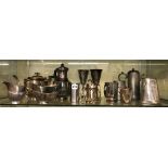 SHELF CONTAINING A THREE PIECE EPNS BATSWING TEA SERVICE, A SIMILAR HOT WATER JUG, EPNS GOBLETS,