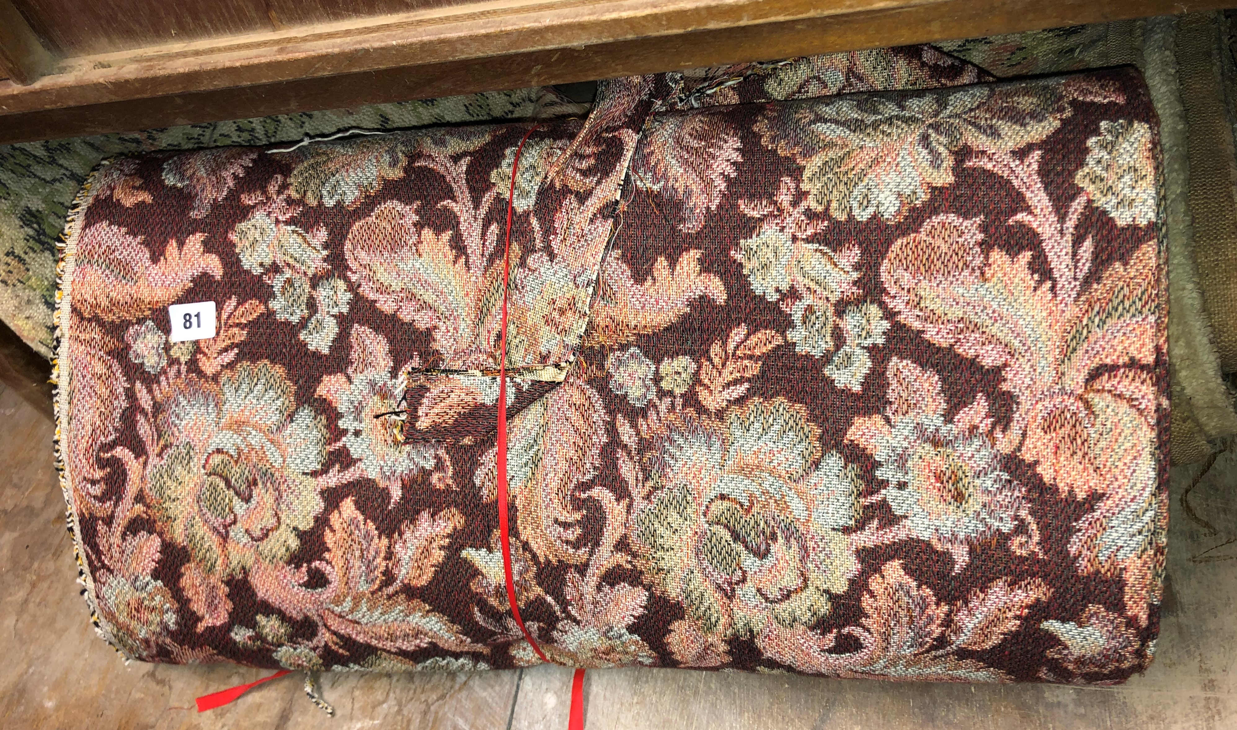 BOLT OF FLORAL FABRIC AND A RUG